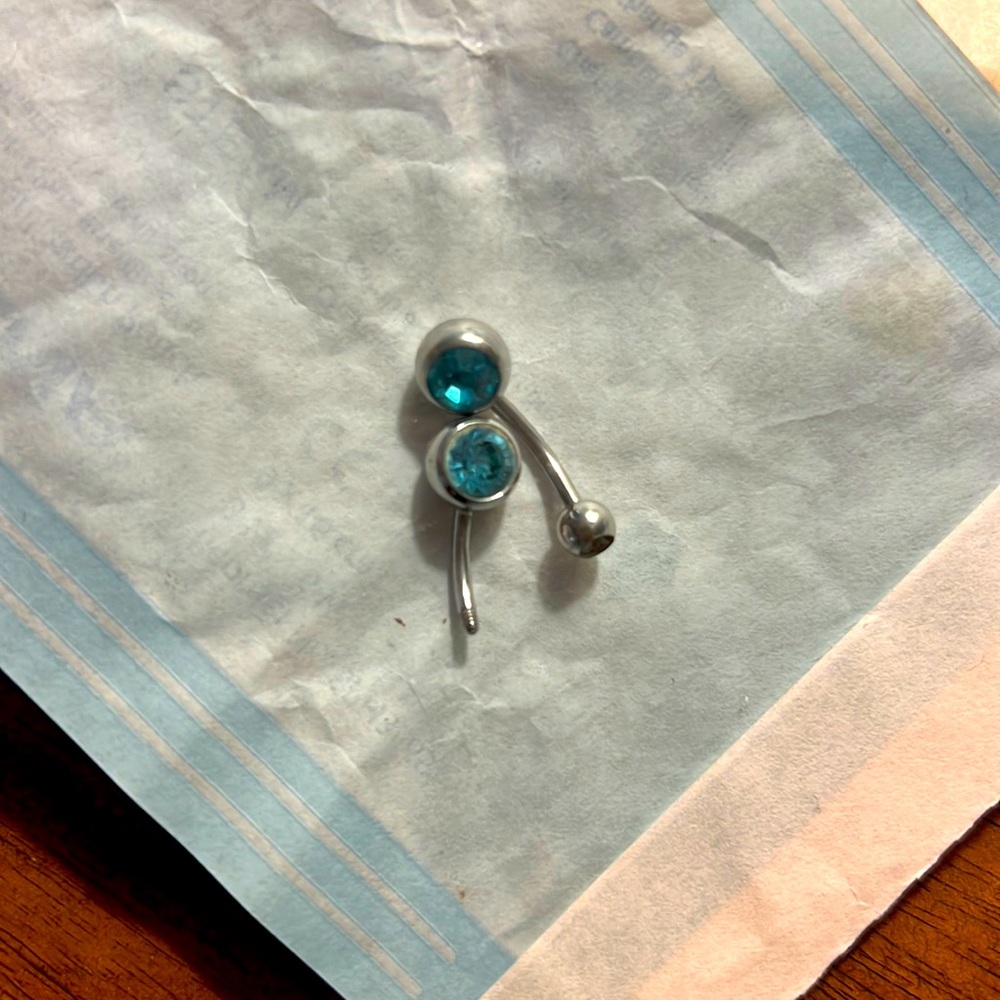Two baby blue belly rings